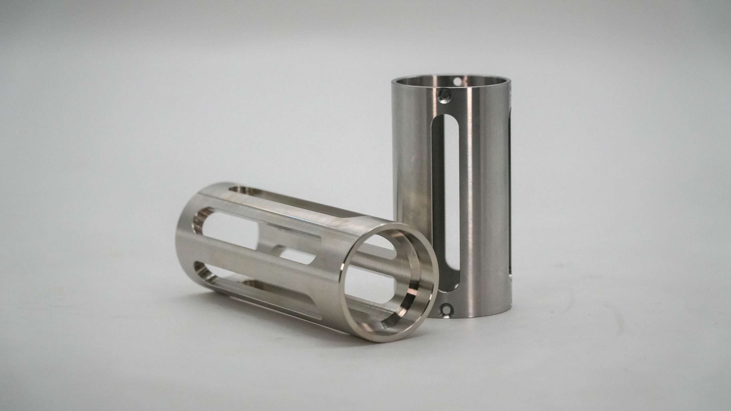 Pair of cylindrical machined parts