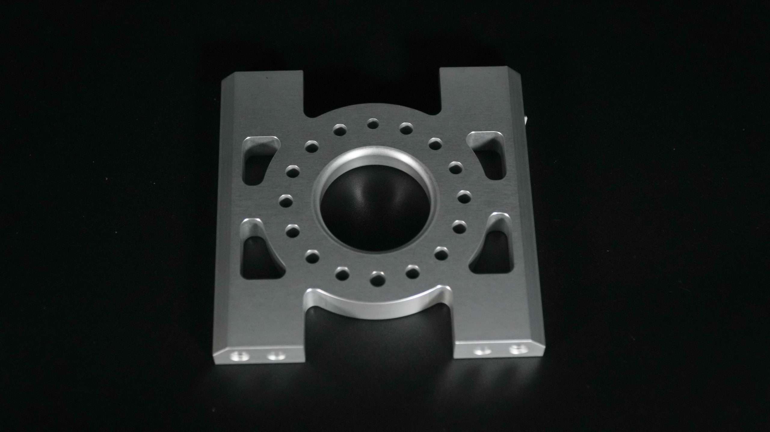 Milled housing photographed on a dark background